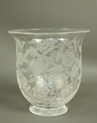 a glass vase with a floral design on it