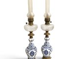 two blue and white vases with candles on top of each other