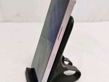 a cell phone that is sitting on top of a stand