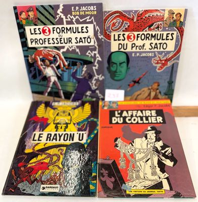 three books of comics are sitting on a table next to each other