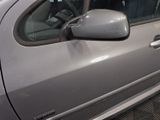 a silver car that is parked in a parking lot