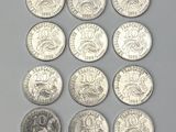 Plusieurs types de pièces de monnaie sont alignées sur une surface grise