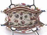 the inside of a white purse with a floral pattern on it
