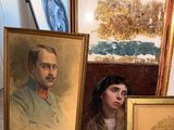 a picture of a man and a woman in front of a painting