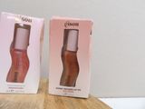 two boxes of nail polish sitting on top of a wooden table
