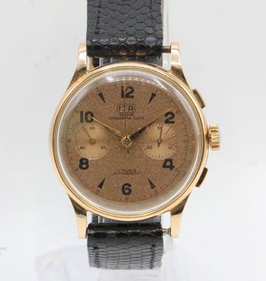 a close up of a watch on a white surface with a black strap