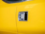 a close up of a door handle on a yellow car