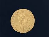 gros plan d'une pièce d'or sur une surface noire