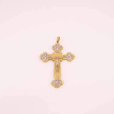 a gold cross pendant with diamonds on a white background