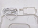 a white tray with a mouse and a charger on it