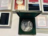a silver coin sitting in a green box on a table