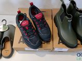 three pairs of men ' s shoes and a shoe box on a table