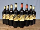 six bottles of wine are lined up in a row on a table