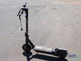 a scooter that is sitting on the ground in the parking lot