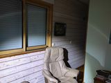 a reclining chair and ottoman in the corner of a living room