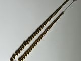 necklace with gold beads on a white surface with a silver chain