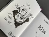 an open book with a drawing of a zombie on it