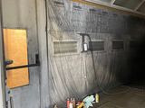 an image of a garage with a lot of stuff on the floor