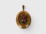 a close up of a gold locke with a brown stone in it