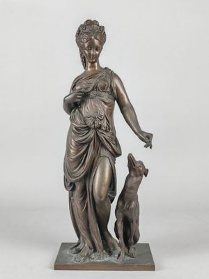 a bronze statue of a woman with a dog on a marble base