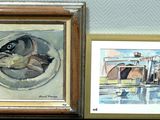 two paintings on a shelf next to each other