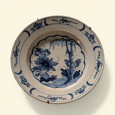 a blue and white plate with a design on it