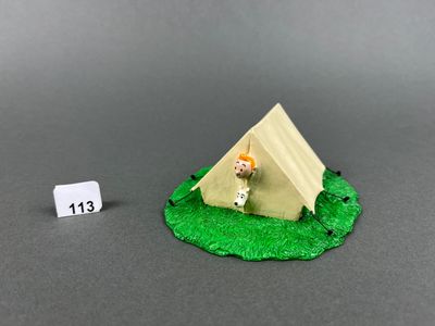 a small toy of a tent with a small doll next to it