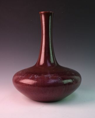 a red vase that is sitting on a table