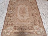 beige and brown area rug with floral design on top of it