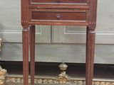 a small wooden table with a drawer on top of it