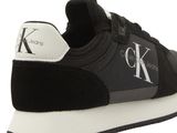 a close up of a black and white sneakers with a logo on the side