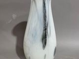 a white and black vase sitting on a table