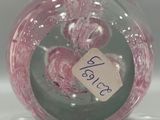a pink glass ball with a tag on it