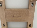 a wooden chair that has a seat made of wood