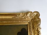 un cadre doré contenant un tableau représentant un homme et une femme