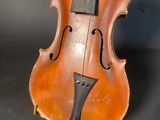 an old violin sitting on top of a black surface