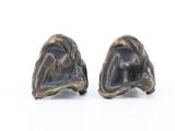 pair of bronze sculptures of a man and woman on a white surface