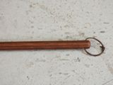 a wooden stick with a metal ring on it