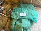 a green cloth on the floor next to a stove