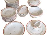 a lot of plates and cups that are sitting on a table