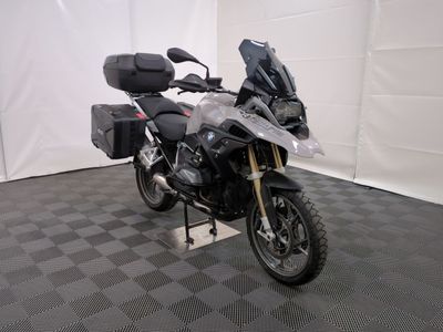 une moto qui est garée dans une pièce dont le sol est en damier