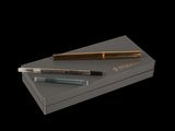 two fountain pens and a box on a black background