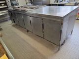 a large stainless steel kitchen island in the middle of a kitchen