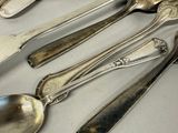a lot of silver spoons and spoon spoons on a table