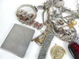 a lot of jewelry on a table with a book