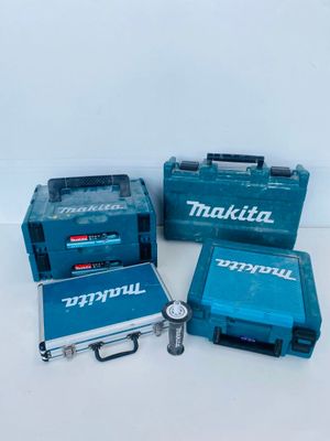 three makita tools are sitting on a white surface