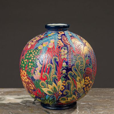 a colorful vase sitting on top of a wooden table