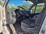 the interior of a van with the door open and the driver ' s seat down