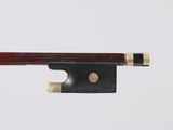 a close up of a violin bow on a white surface