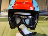 a helmet and goggles sitting on top of a green car